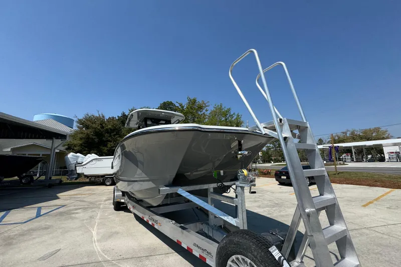 Slide: The Image of 2026 Caymas 29 CT boat on trailer under clear blue sky. - 7