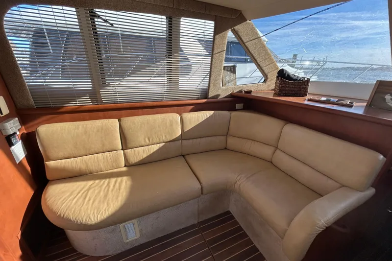 Slide: The Image of Luxurious interior of 2005 Silverton 38 Convertible yacht with beige leather seating. - 10