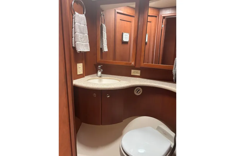Slide: The Image of Luxurious bathroom interior of 2005 Silverton 38 Convertible yacht with wooden cabinetry. - 13