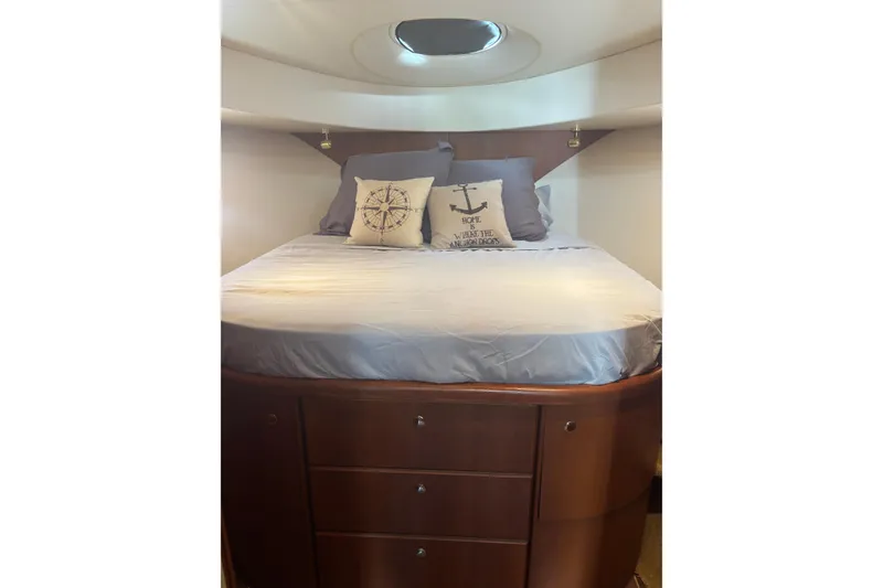 Slide: The Image of Cozy bedroom in 2005 Silverton 38 Convertible yacht with nautical-themed pillows. - 14