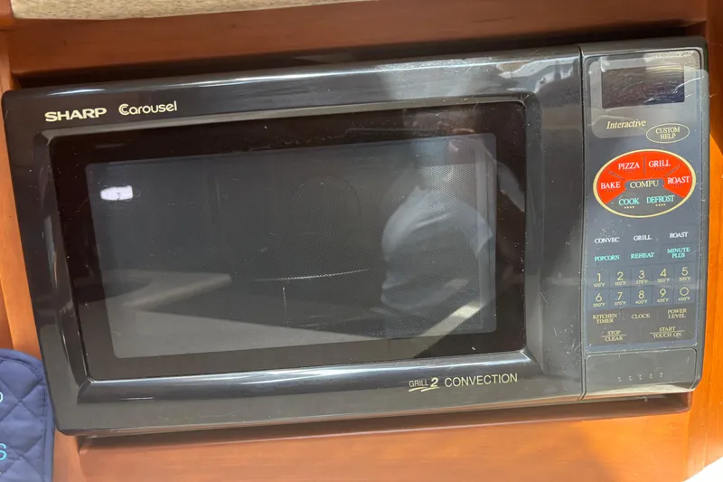 Slide: The Image of Sharp Carousel microwave in a 2005 Silverton 38 Convertible boat kitchen. - 17