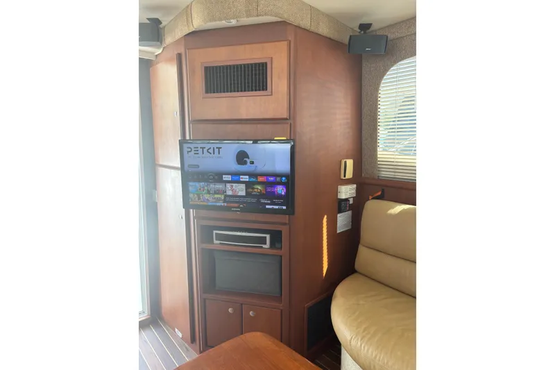 Slide: The Image of Interior of 2005 Silverton 38 Convertible yacht with TV and seating area. - 8