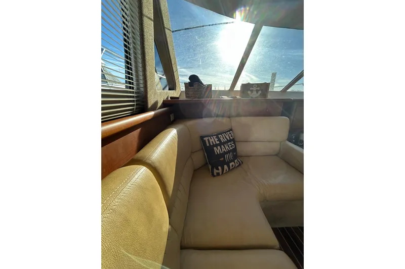 Slide: The Image of Interior of 2005 Silverton 38 Convertible yacht with sunlit seating area. - 9