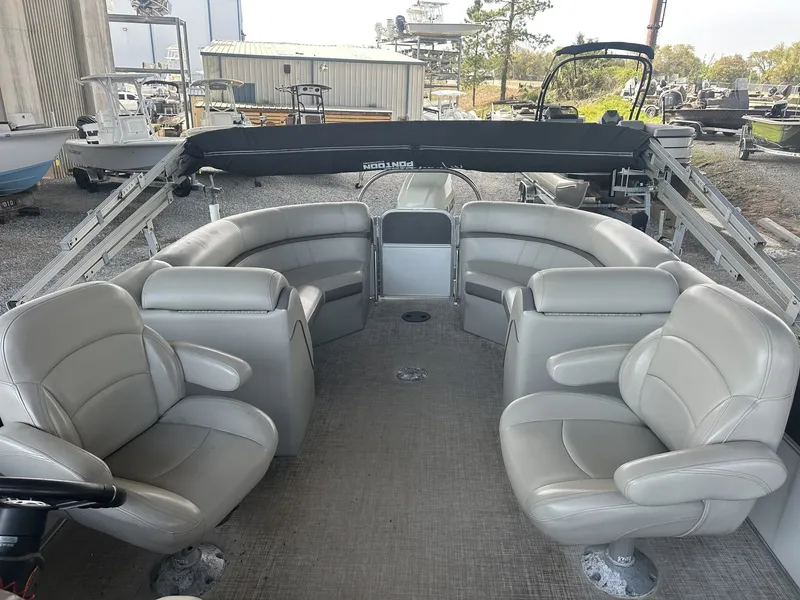 Slide: The Image of 2018 South Bay 200 Series Tritoon with gray leather seating. - 9
