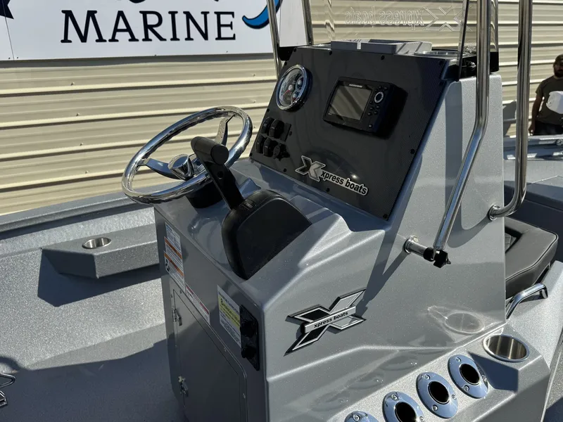 Slide: The Image of 2026 Xpress H20B Bay boat console with steering and instruments. - 6
