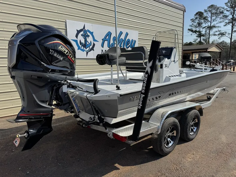 Slide: The Image of Xpress Hyper-Lift H22B-200HP boat, 2026 model, on trailer outside building. - 7