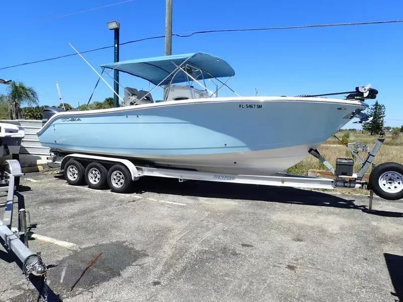 The Image of 2020 Cobia 280 Center Console on trailer, blue sky. - 1