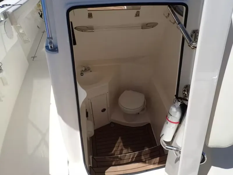 Slide: The Image of Interior of 2020 Cobia 280 Center Console with toilet and sink. - 12