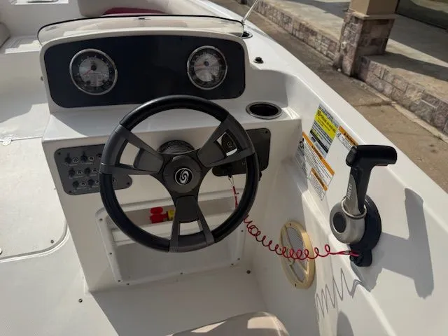 Slide: The Image of 2014 Hurricane SSR188 boat console with steering wheel and controls. - 16