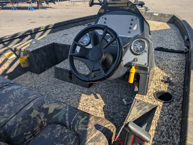 Slide: The Image of Interior of a 2018 Lowe Stinger 175C boat with steering console. - 7