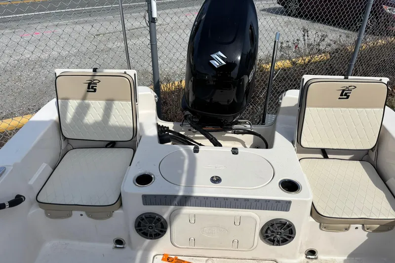 Slide: The Image of 2023 Carolina Skiff 21 LS boat interior with seating and Suzuki outboard motor. - 3