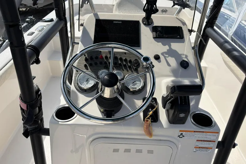 Slide: The Image of 2023 Carolina Skiff 21 LS boat dashboard with steering wheel and control panel. - 5