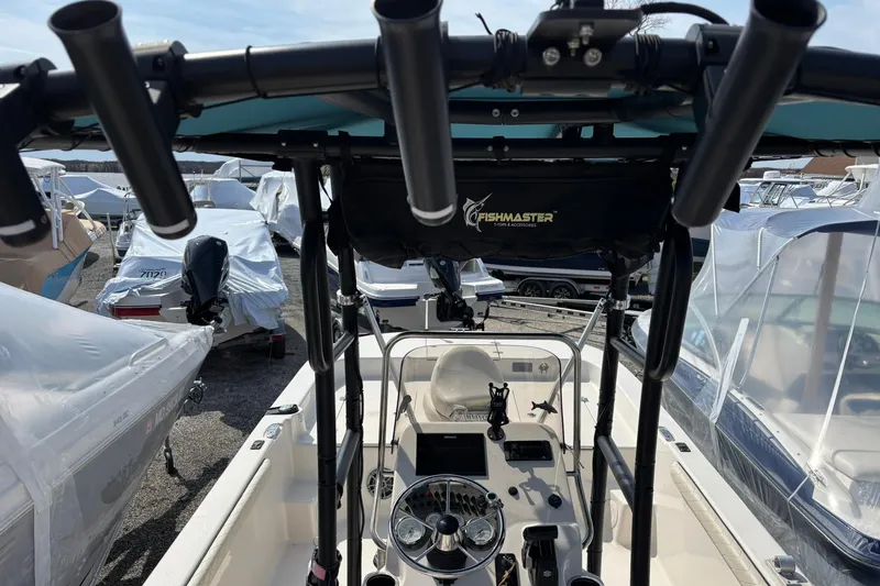 Slide: The Image of 2023 Carolina Skiff 21 LS boat interior with Fishmaster accessories and covered boats in background. - 8