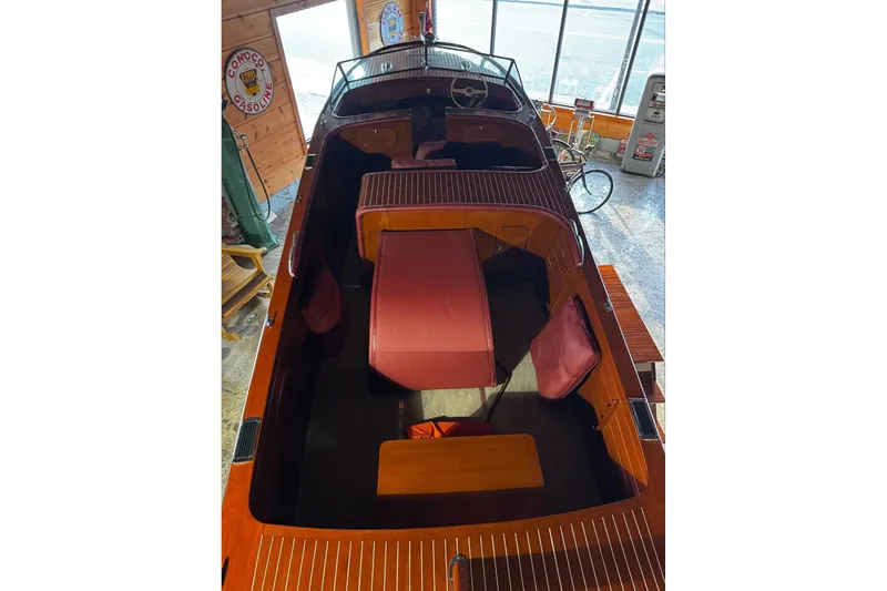 Slide: The Image of 1948 Chris-Craft Sportster 25 boat interior with wooden finish and red seating. - 11