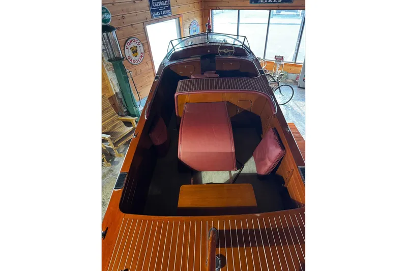Slide: The Image of 1948 Chris-Craft Sportster 25 boat interior with vintage wooden design and red seating. - 12