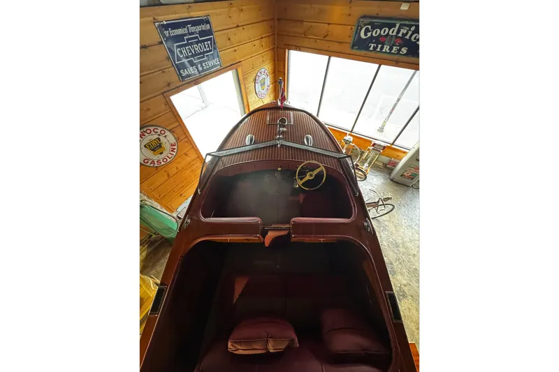 Slide: The Image of 1948 Chris-Craft Sportster 25 boat in vintage showroom with retro signs. - 16