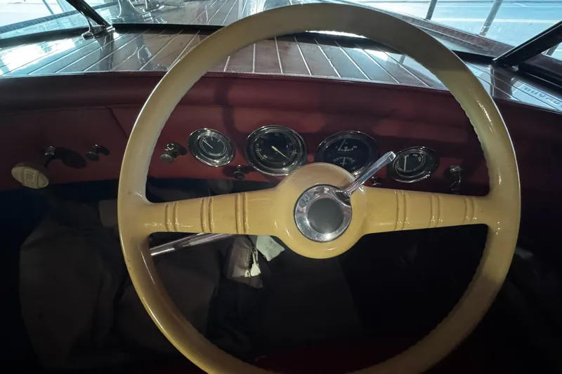 Slide: The Image of Steering wheel and dashboard of a 1948 Chris-Craft Sportster 25 boat. - 17