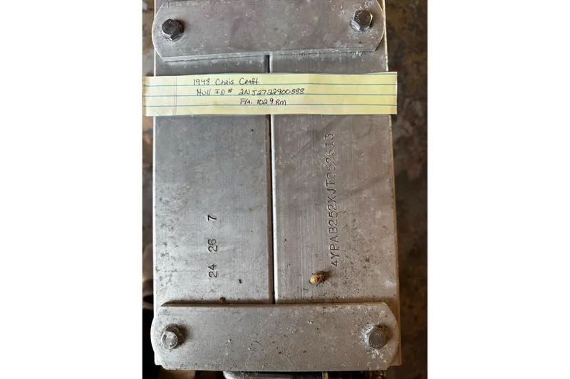 Slide: The Image of 1948 Chris-Craft Sportster 25 metal component with handwritten note and serial numbers. - 23