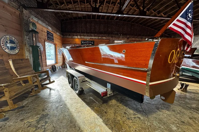 Slide: The Image of 1948 Chris-Craft Sportster 25 wooden boat on trailer in rustic garage setting. - 6