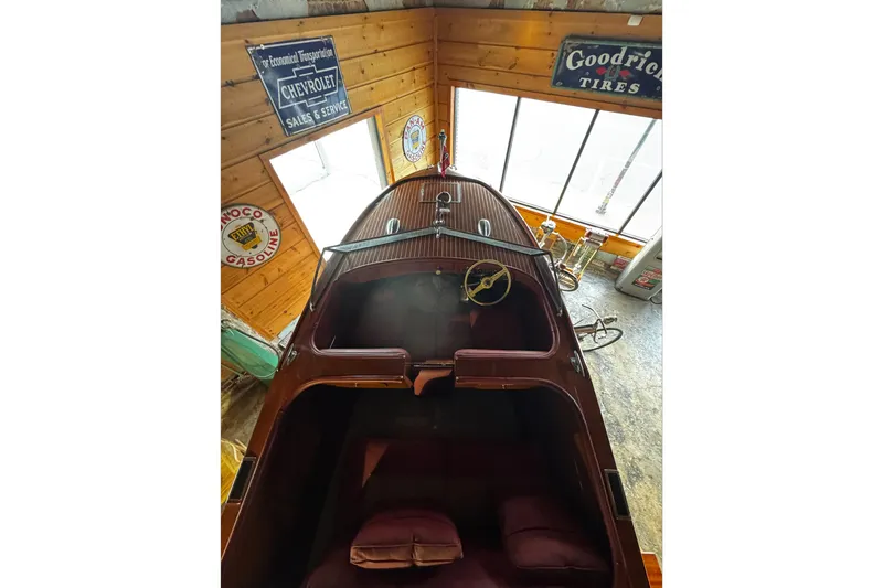 Slide: The Image of 1948 Chris-Craft Sportster 25 in vintage garage with retro signs. - 7