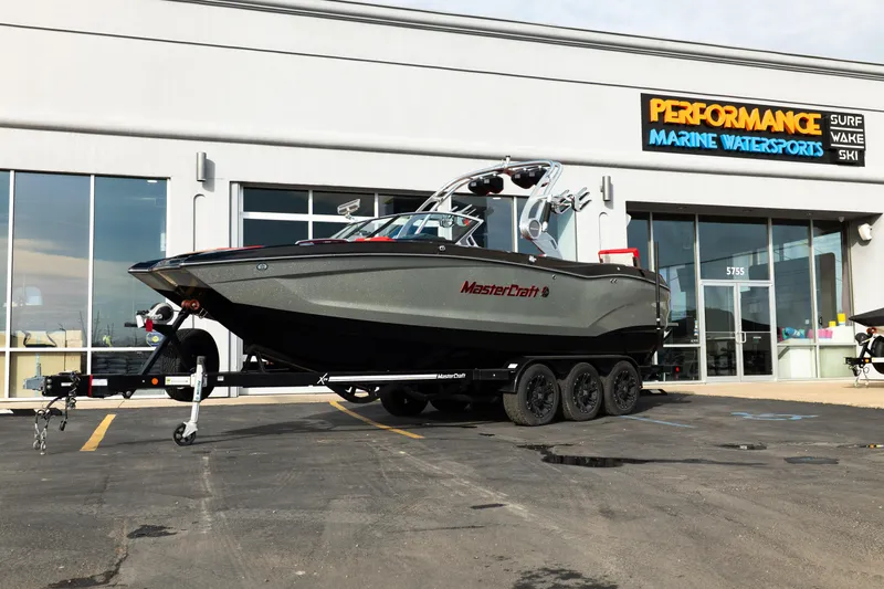 The Image of 2021 MasterCraft X24 boat on trailer outside Performance Marine Watersports store. - 0