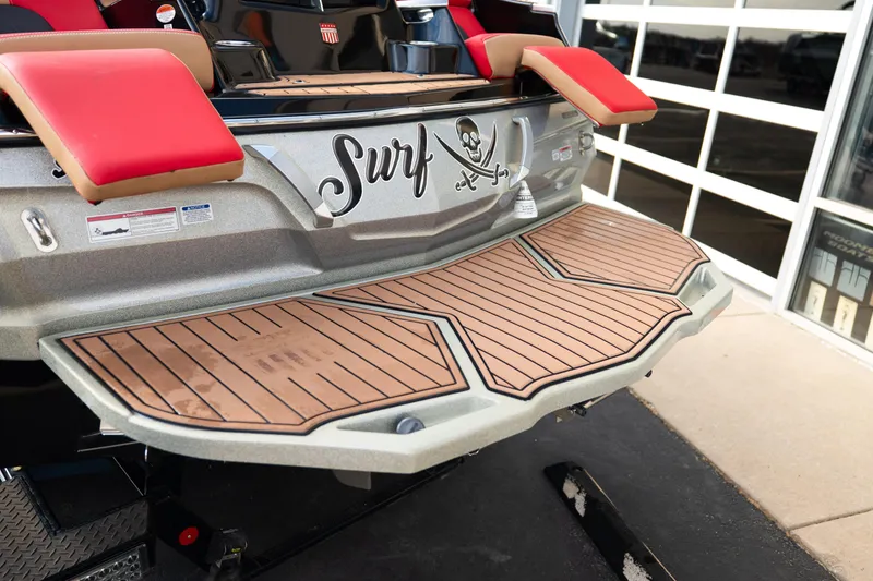 Slide: The Image of 2021 MasterCraft X24 boat with teak-style swim platform and "Surf" decal. - 10