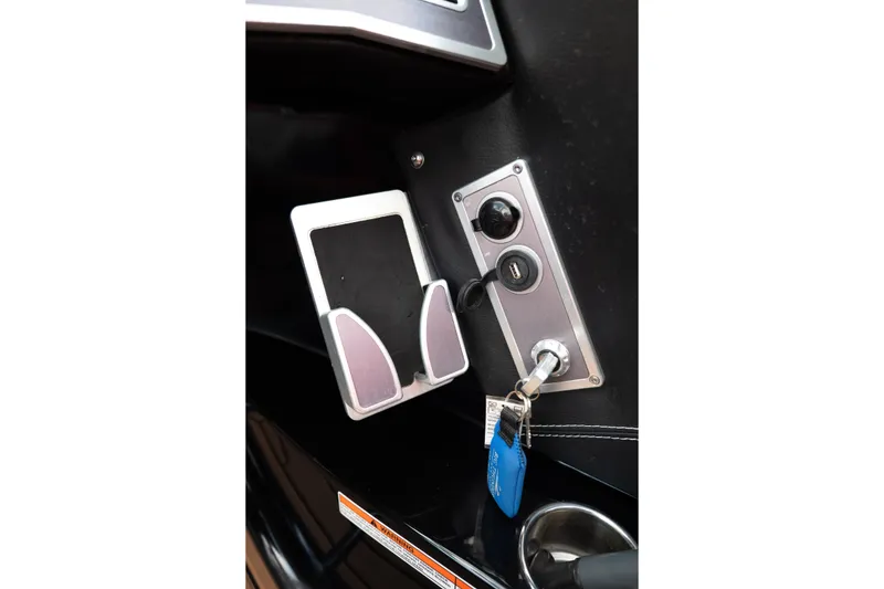 Slide: The Image of Control panel of 2021 MasterCraft X24 boat with key ignition and USB port. - 13