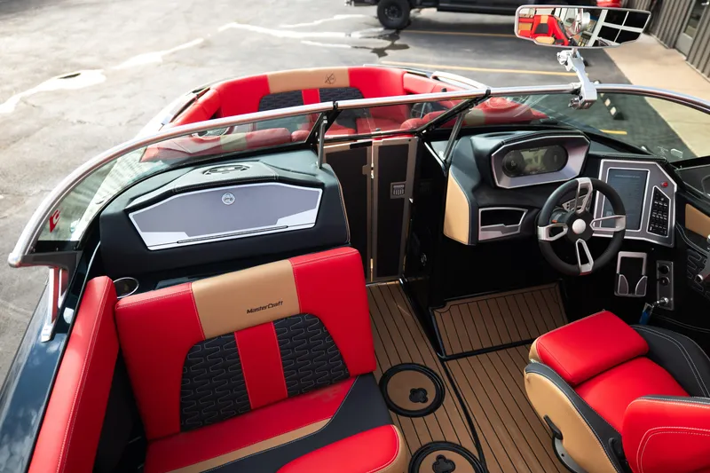 Slide: The Image of Interior of a 2021 MasterCraft X24 boat with red and tan seating. - 15