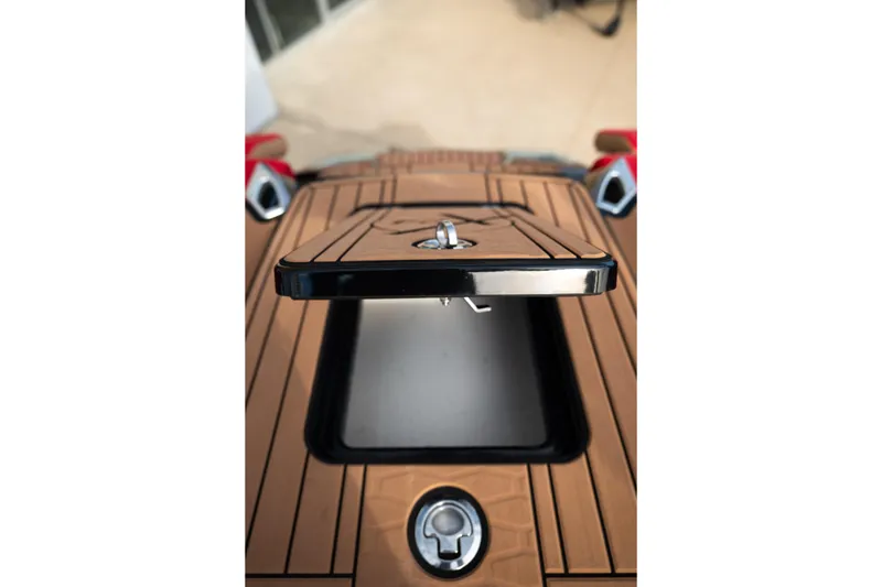 Slide: The Image of 2021 MasterCraft X24 boat deck with open storage compartment. - 16