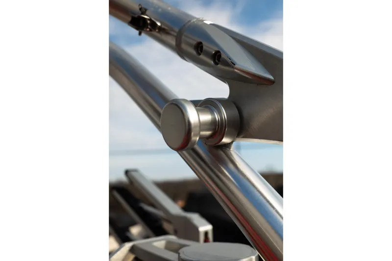 Slide: The Image of Close-up of 2021 MasterCraft X24 boat's sleek metal framework under blue sky. - 18