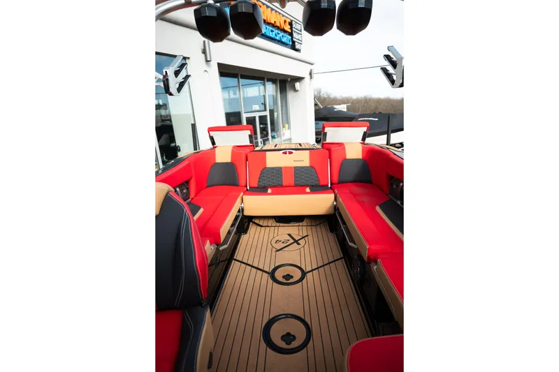Slide: The Image of 2021 MasterCraft X24 boat interior with red and tan seating, showcasing luxury design. - 24