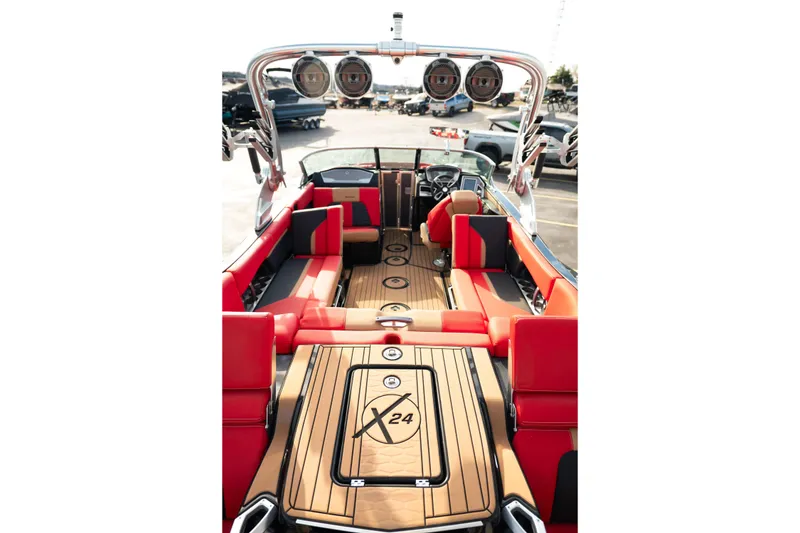 Slide: The Image of 2021 MasterCraft X24 boat interior with red seating and teak flooring. - 33