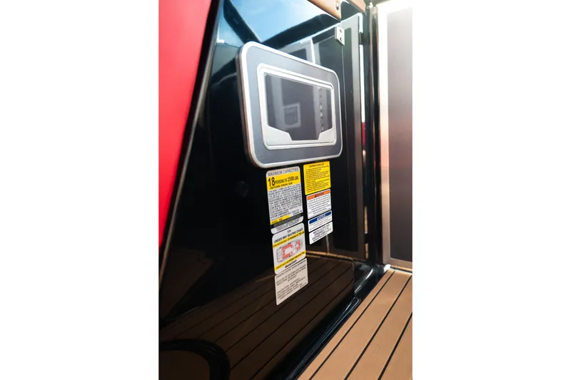 Slide: The Image of 2021 MasterCraft X24 boat interior with safety labels and control panel. - 36