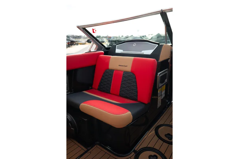 Slide: The Image of 2021 MasterCraft X24 boat interior with red and tan seating, showcasing luxury design. - 37