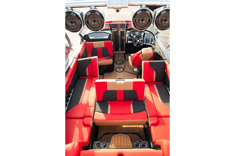 Slide: The Image of 2021 MasterCraft X24 boat interior with red and black seating, premium audio system. - 41