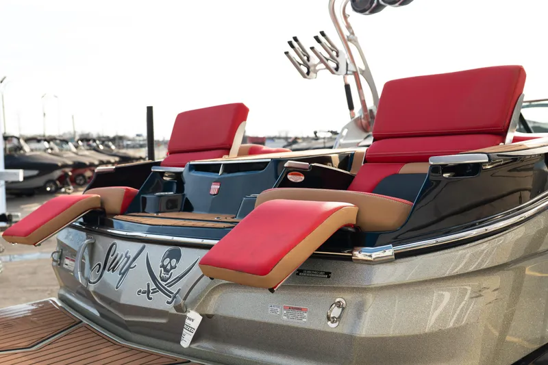 Slide: The Image of 2021 MasterCraft X24 boat with red seats and surf-themed design. - 8