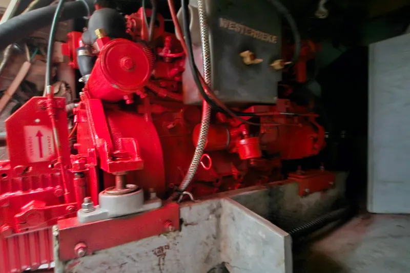 Slide: The Image of Engine compartment of a 1985 Nonsuch 30 sailboat, featuring a red Westerbeke engine. - 15