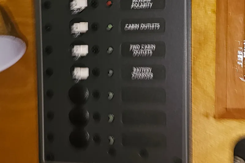 Slide: The Image of Electrical panel on a 1985 Nonsuch 30 sailboat with labeled switches. - 18