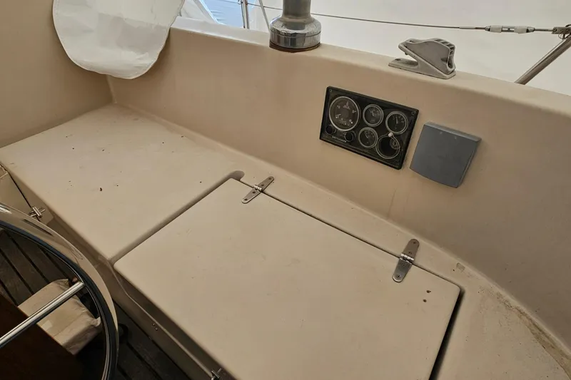 Slide: The Image of 1985 Nonsuch 30 sailboat cockpit with instrument panel and storage compartments. - 2