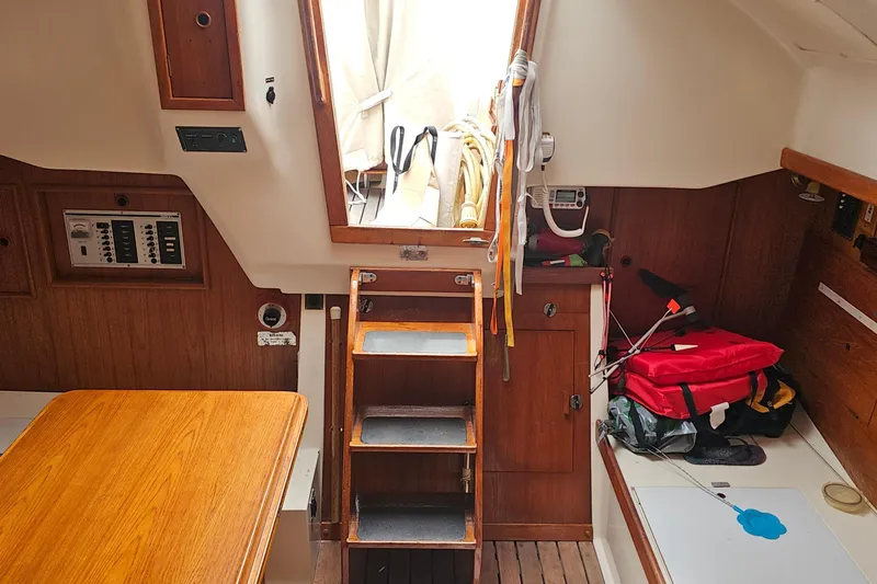 Slide: The Image of Interior of a 1985 Nonsuch 30 sailboat with wooden finishes and nautical equipment. - 22