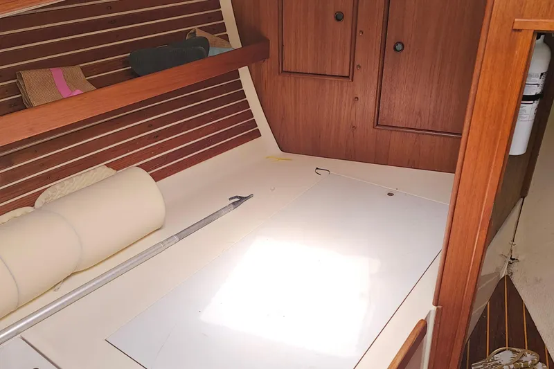 Slide: The Image of Interior of 1985 Nonsuch 30 sailboat with wooden cabinetry and storage space. - 23
