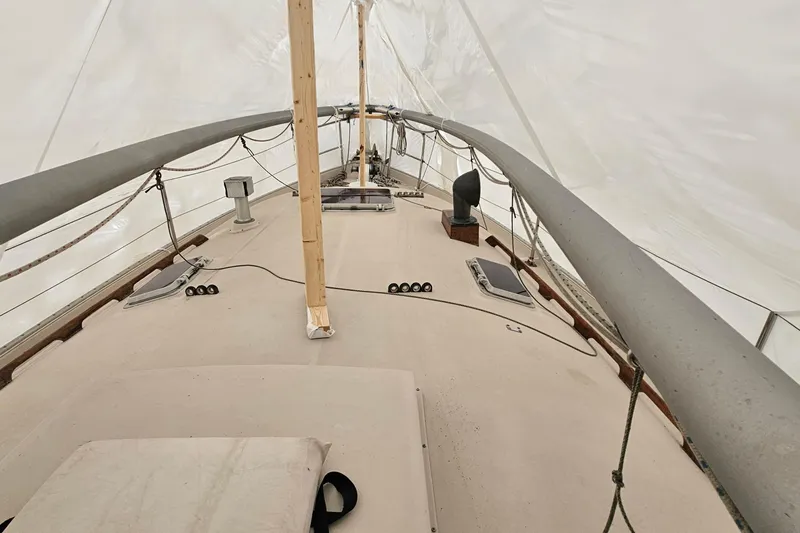 Slide: The Image of 1985 Nonsuch 30 sailboat deck under cover, showcasing mast and rigging. - 3