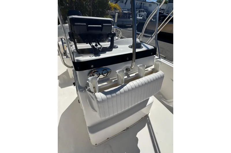 Slide: The Image of 2003 Boston Whaler 170 Montauk boat console with steering wheel and rod holders. - 11