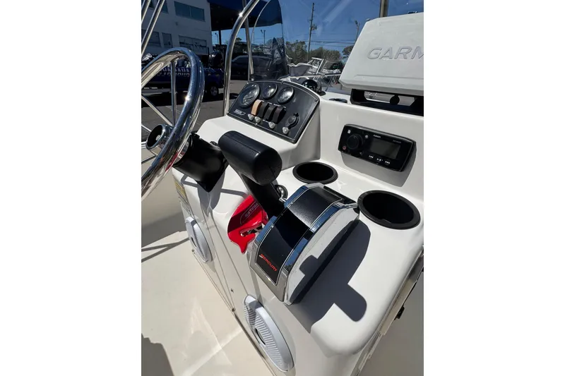Slide: The Image of 2003 Boston Whaler 170 Montauk boat console with steering wheel and controls. - 14