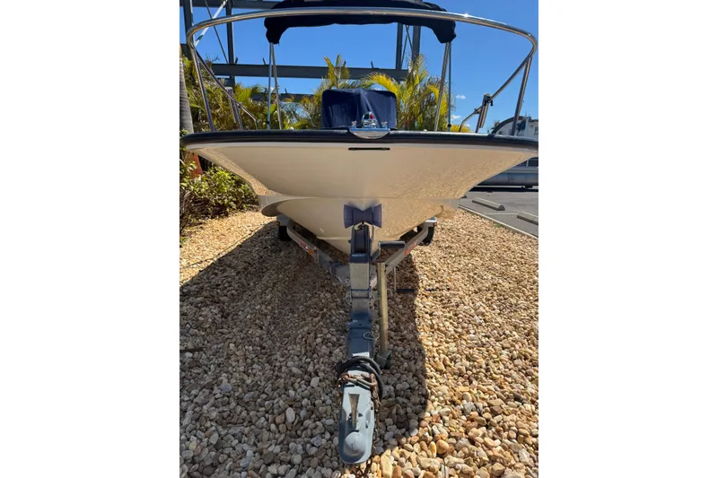 Slide: The Image of 2003 Boston Whaler 170 Montauk boat on trailer, parked on gravel. - 18