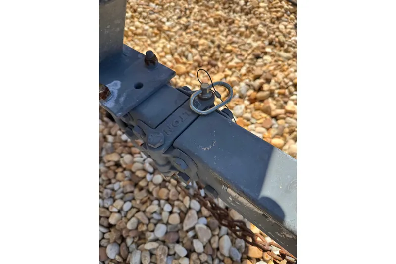 Slide: The Image of Trailer hitch detail on gravel, related to 2003 Boston Whaler 170 Montauk. - 19