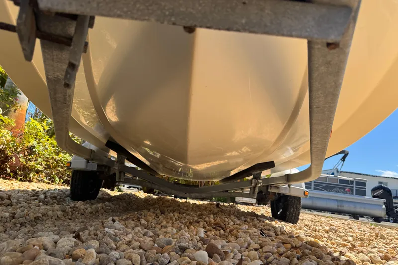 Slide: The Image of Underneath view of a 2003 Boston Whaler 170 Montauk boat on a trailer. - 20