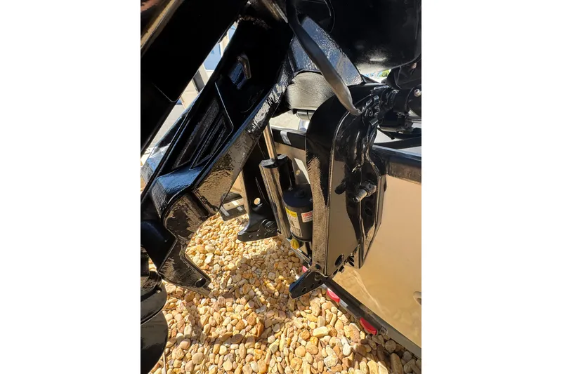 Slide: The Image of 2003 Boston Whaler 170 Montauk boat motor detail on rocky ground. - 3