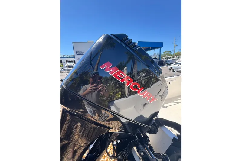 Slide: The Image of Mercury outboard motor on a 2003 Boston Whaler 170 Montauk boat, sunny day reflection. - 4