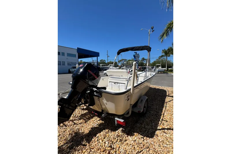 Slide: The Image of 2003 Boston Whaler 170 Montauk boat with outboard motor on a sunny day. - 6